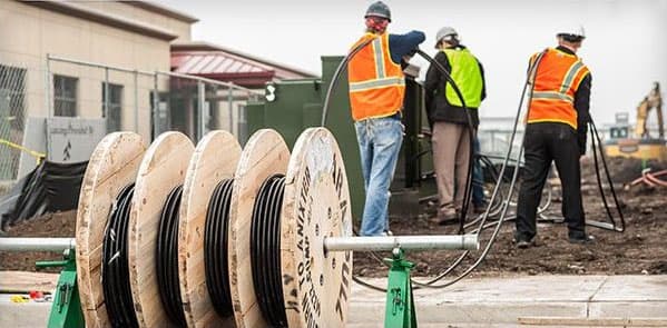 Electrical workers with cable reels