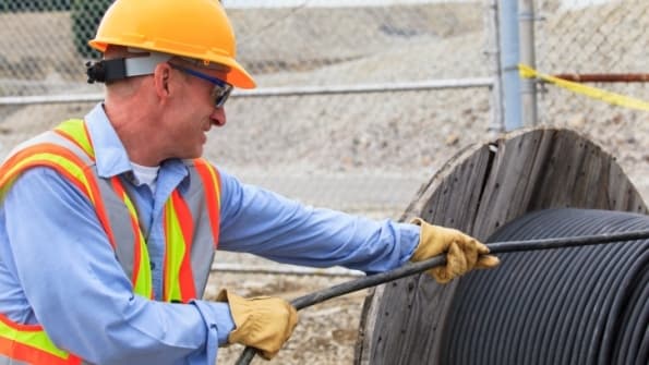 Worker handling industrial cables